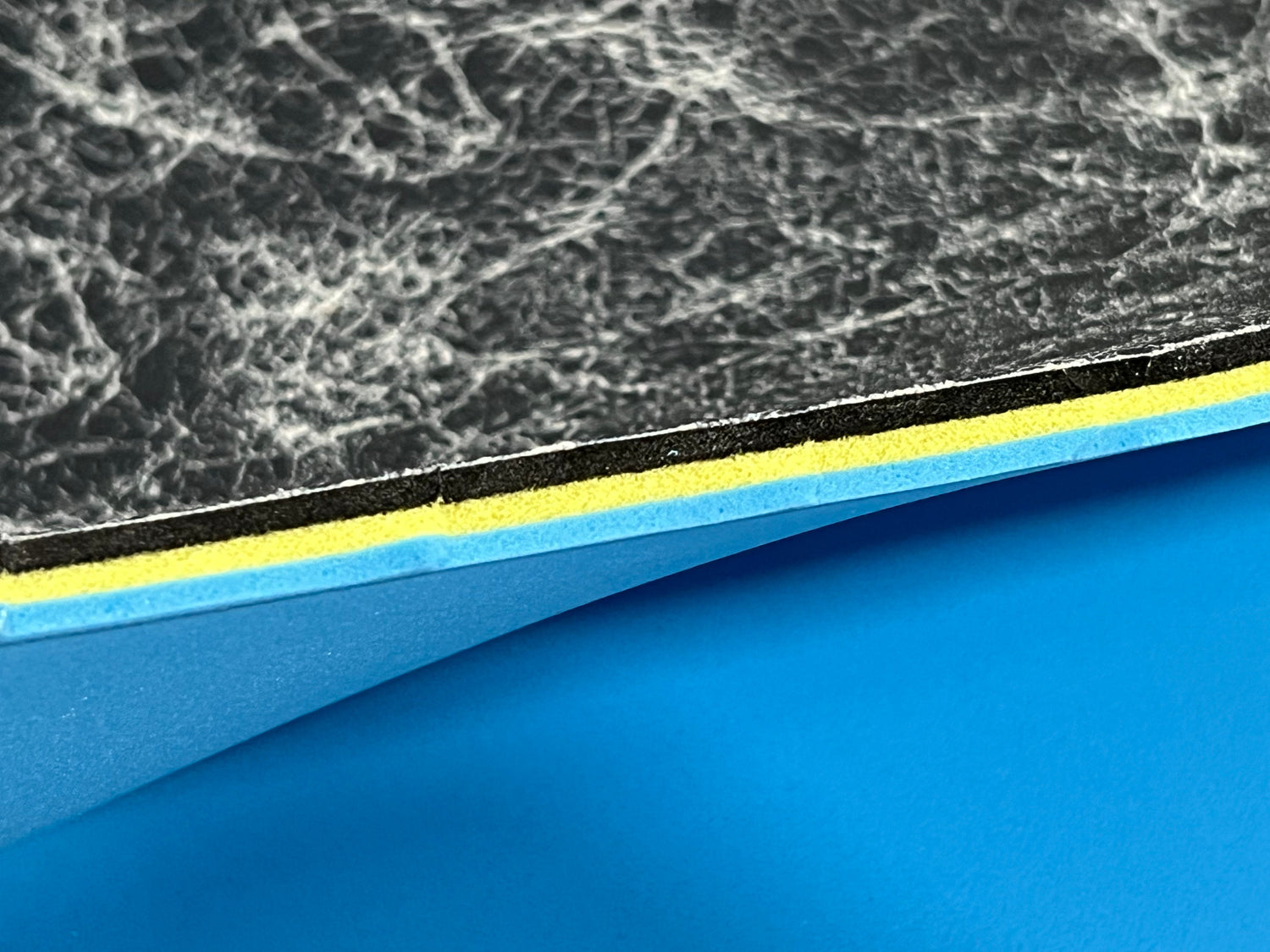 Close-up of textured edge of our 3/8" insole sheet which combines 3 different insole materials plus the Pure silver infused AG 2.0 topliner.