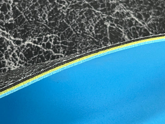 Close-up of textured edge of our 3/16" insole sheet which combines 3 different insole materials plus the Pure silver infused AG 2.0 topliner.
The composition is 1/16" Black Foam Fusion foam on top, then the 1/16" VeloShox foam in the middle with the 1.16" BounceBlu foam at the bottom.