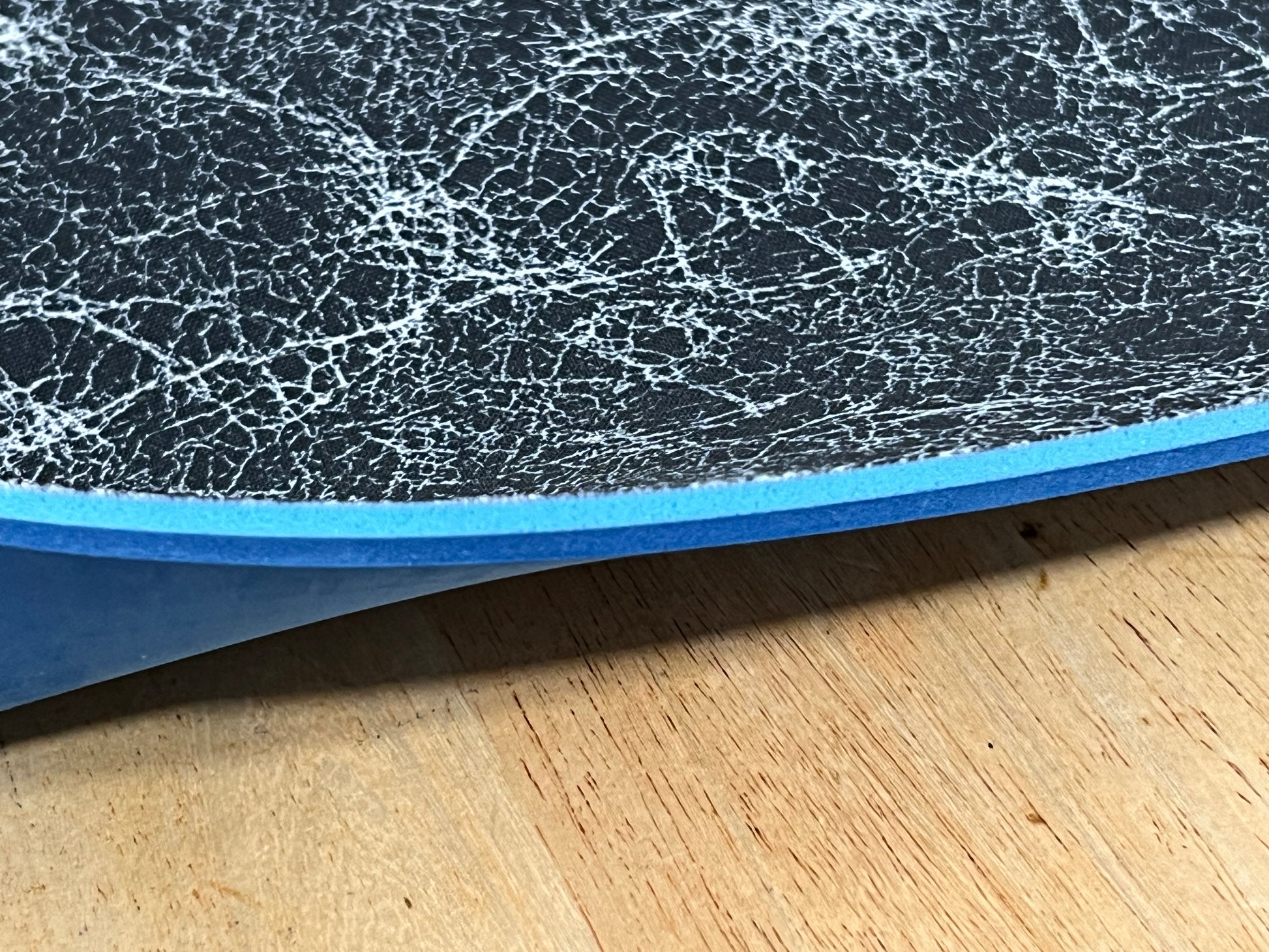 Close-up of textured edge of our 1/4" insole sheet which combines 2 different insole materials plus the Pure silver infused AG 2.0 topliner.
The composition is 1/8"  BounceBlu foam on top, then the 1/8" Plush EVA foam at the bottom.