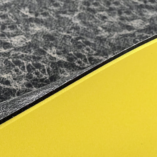 Close up image of side profile of a 1/4" sheet that has 3 layers, the black thin footbed layer, the 1/8"FoamFuzion Layer and the 1/8" VeloShox Layer.