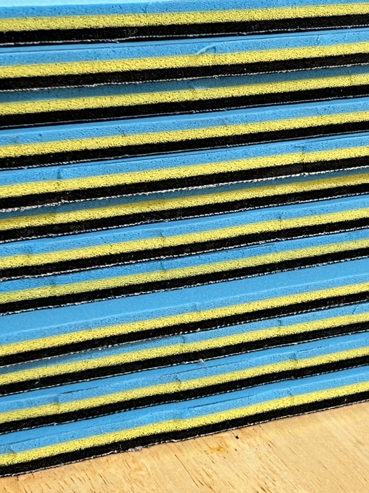 Close-up of textured edge of our 3/8" insole sheet which combines 3 different insole materials plus the Pure silver infused AG 2.0 topliner.
This photo is of a stack 12 of our 3/8" insole sheets from the side profile.
Each sheet's composition is 1/8" Black Foam Fusion foam on top, then the 1/8" VeloShox foam in the middle with the 1.8" BounceBlu foam at the bottom.