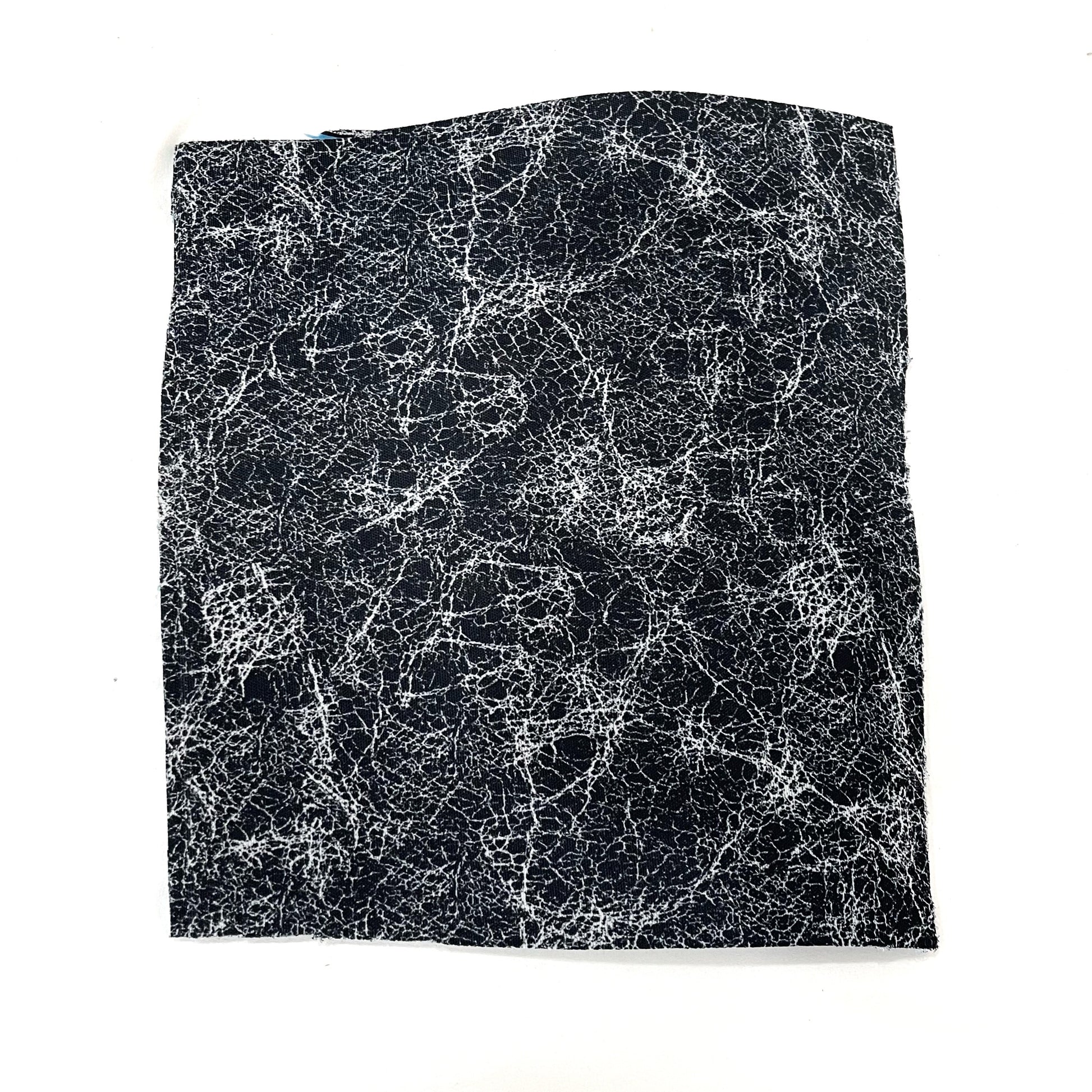 close up view of pure silver infusd nylon footbed.
Nylon is black and the silver fibers are well silver. and the pattern is a disarray of imperfect lines in an all over splatter pattern