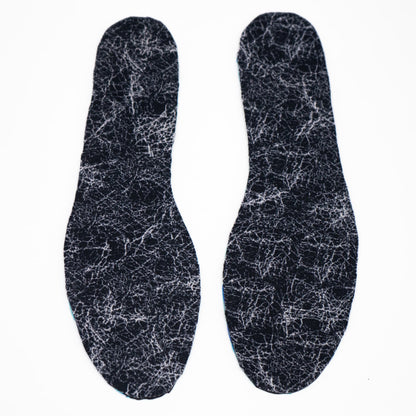 overhead shot of two cut out insoles from our insole sheets. The footbed is the Silver AG 2.0 footbed that is black with white lines in a marbled pattern.