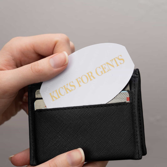 Cover image of a shoeslyde with Kicks For Gents on it being pulled out of a card holder wallet by a hand.